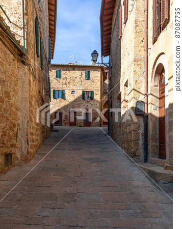 Narrow pedestrian way in an ancient Monticchiello town in Tuscany. Val d'Orcia, Italy Narrow pedestrian way in an ancient Monticchiello town in Tuscany. Val d'Orcia, Italy 87087755