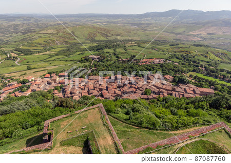 Narrow streets of old little Radicofani village with tiled roofs and church. Val d'Orcia. Tuscany Narrow streets of old little Radicofani village with tiled roofs and church. Val d'Orcia. Tuscany 87087760