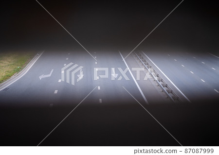 forward and left arrow on the track. White arrow sign painted on black asphalt. Transport background. Three-lane modern asphalt road forward and left arrow on the track. White arrow sign painted on black asphalt. Transport background. Three-lane modern asphalt road 87087999
