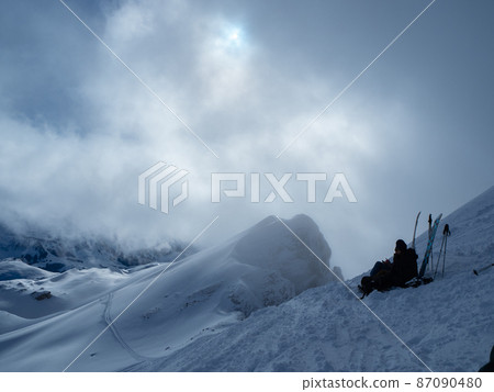 Ski tourers having a pause on the summit of Haengst, Switzerland Ski tourers having a pause on the summit of Haengst, Switzerland 87090480