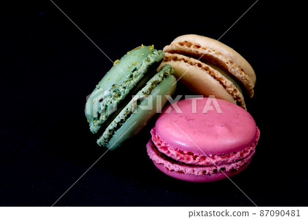 The Netherlands. January 2022. Close up of colorful macarons against a black background. 87090481