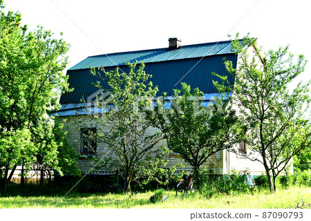 House surrounded by fruit trees. 87090793