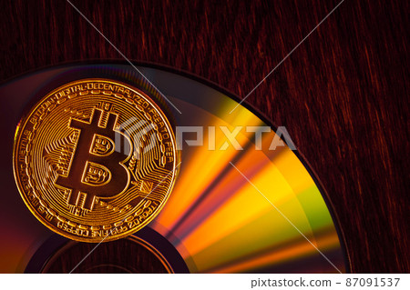 Bitcoin coin on a CD - DVD, background for design Bitcoin coin on a CD - DVD, background for design 87091537