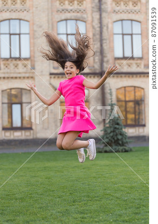 Girl jumping outdoors. Feel free. Jump of happiness. Girl jumping outdoors. Feel free. Jump of happiness. 87091539