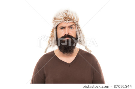 sad mature guy with beard in earflape hat isolated on white background, casual sad mature guy with beard in earflape hat isolated on white background, casual 87091544