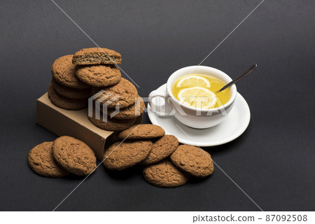 Oatmeal biscuits as pastry for cup of tea with lemon Oatmeal biscuits as pastry for cup of tea with lemon 87092508