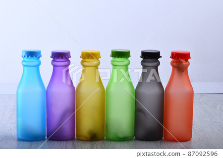 Set of bottles in different color. Row of colorful drinks 87092596