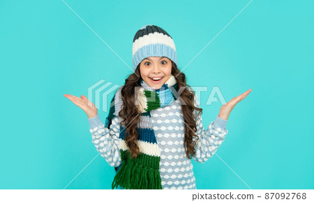 express positive emotion. winter fashion. amazed kid with curly hair in hat and scarf. express positive emotion. winter fashion. amazed kid with curly hair in hat and scarf. 87092768