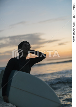 A man surfing in the morning sea A man surfing in the morning sea 87092988