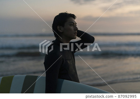 A man surfing in the morning sea A man surfing in the morning sea 87092995