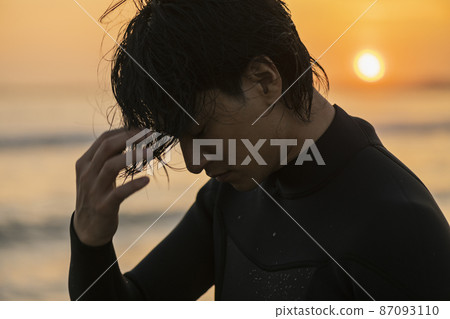 A man surfing in the morning sea A man surfing in the morning sea 87093110