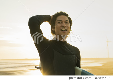 A man surfing in the morning sea A man surfing in the morning sea 87093328