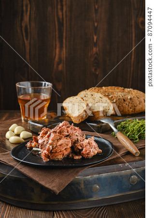 Homemade canned fallow deer stew meat on a plate 87094447