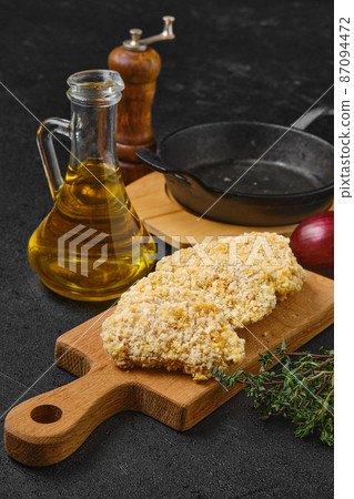 Chicken nuggets in breading ready for frying 87094472