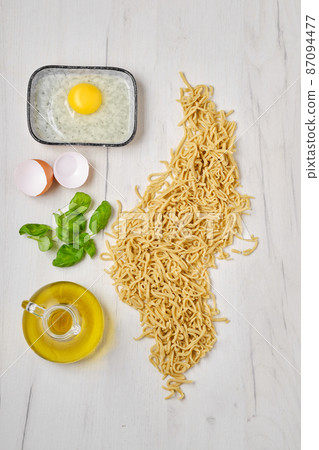 Overhead view of homemade noodles on kitchen table 87094477