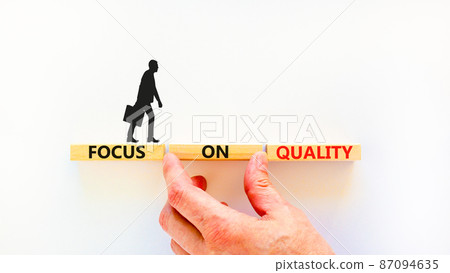 Focus on quality symbol. Concept words Focus on quality on blocks on beautiful white table white background. Businessman hand. Business, focus on quality concept. Copy space. Focus on quality symbol. Concept words Focus on quality on blocks on beautiful white table white background. Businessman hand. Business, focus on quality concept. Copy space. 87094635