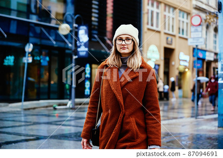 Woman walking at city street Woman walking at city street 87094691
