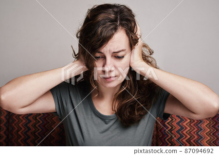 Woman covered her ears with hands, strong head pain Woman covered her ears with hands, strong head pain 87094692