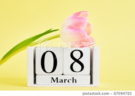 Calendar and flower on yellow background Calendar and flower on yellow background 87094785