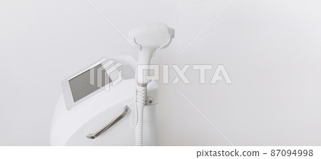 A laser hair removal machine with working part of the epilator in a modern beauty salon on white background. Underarm Laser Hair Removal concept 87094998