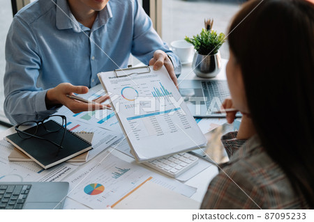 Business team meeting present, investor colleagues discussing new plan financial graph data on office table with laptop and digital tablet, Finance, accounting, investment. Business team meeting present, investor colleagues discussing new plan financial graph data on office table with laptop and digital tablet, Finance, accounting, investment. 87095233