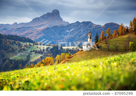 Santa Barbara church at the autumn Dolomite Alps 87095299