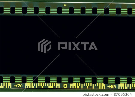 Film scan. Digital number and bezel on film photographs scanned. 35mm film frames strip scanned with signs of usage on bezel. blank old film strip frame background. Retro films border with numbers. 87095364