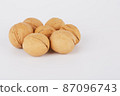 Walnuts on a white background lie in the shape of a circle 87096743