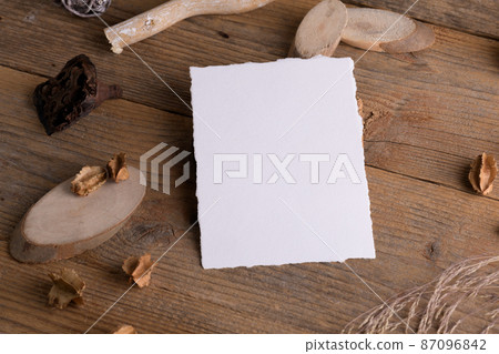 Vertical card mockup with torn edges for wedding mockup invitation on a wooden rustic background with boho decoration Vertical card mockup with torn edges for wedding mockup invitation on a wooden rustic background with boho decoration 87096842