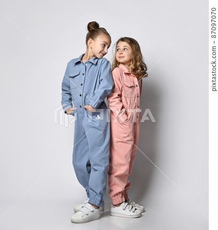 Two smiling girls, friends, sisters in blue and 87097070
