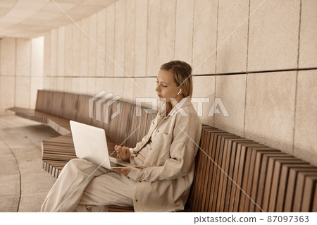 A young woman answers a video call. A young woman answers a video call. 87097363