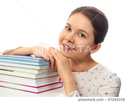 Smiling woman with a stack of books Smiling woman with a stack of books 87099208