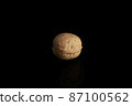 One inshell walnut on a black background 87100562