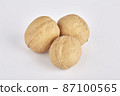Three walnuts lie side by side on a white background 87100565