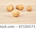 Walnuts lie in the center on a wooden background 87100573