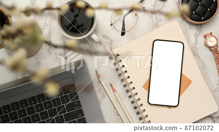 Modern female office desk with smartphone mockup in marble white background. 87102072