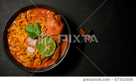 Overhead shot, Khao Soi Kai or chicken curry with seasoning and egg noodles Overhead shot, Khao Soi Kai or chicken curry with seasoning and egg noodles 87102089