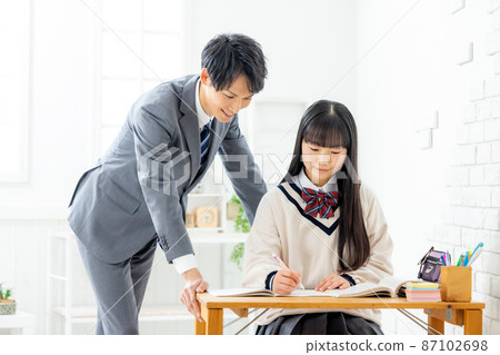 Girls and teachers studying in cram school 87102698