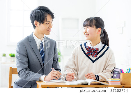 Girls and teachers studying in cram school Girls and teachers studying in cram school 87102734