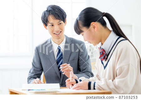 Girls and teachers studying in cram school Girls and teachers studying in cram school 87103253