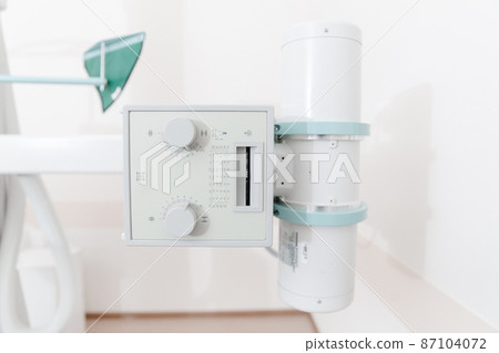 Hospital Radiology Room. X-ray department in modern hospital. Medical equipment. scan machine for fluorography. Technician adjusting an xray machine. Scanning chest, heart, lungs in modern clinic 87104072