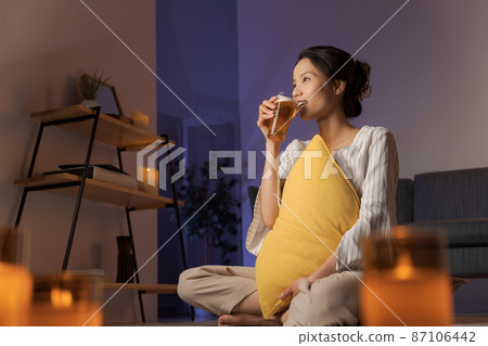 Woman drinking beer Woman drinking beer 87106442
