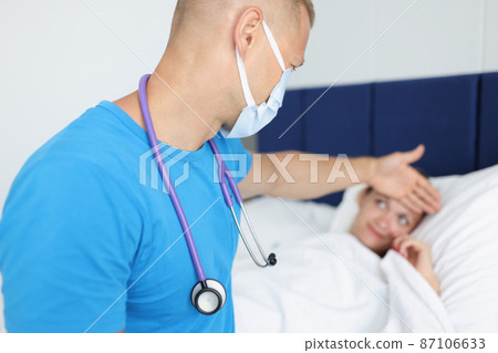 Doctor with covid-19 patient lying in bed at home 87106633