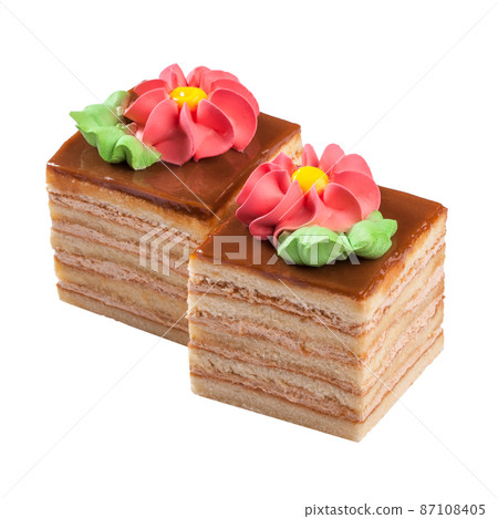 Layered sponge cake topped with caramel and decorated with buttercream flowers Layered sponge cake topped with caramel and decorated with buttercream flowers 87108405