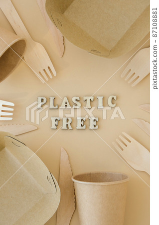 PLASTIC FREE text around Eco friendly, disposable, recyclable, compostable tableware. Paper food boxes, dishes on neutral beige background. Sustainable lifestyle concept. Flat lay 87108881