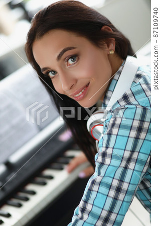Female playing on white and black keyboards on piano, beautiful creative musician 87109740