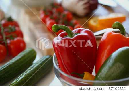 Bowl with fresh vegetables inside, ripe red pepper, cucumber, tomatoes for salad Bowl with fresh vegetables inside, ripe red pepper, cucumber, tomatoes for salad 87109821