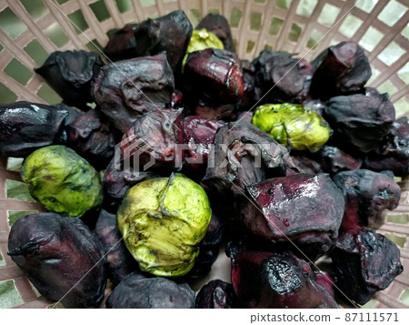Seasonal water chestnuts for sale in a local market. selective focus Seasonal water chestnuts for sale in a local market. selective focus 87111571