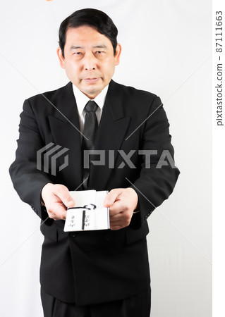 Senior man handing over the incense Senior man handing over the incense 87111663
