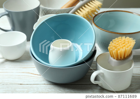 Concept of dish washing on white wooden table Concept of dish washing on white wooden table 87111689